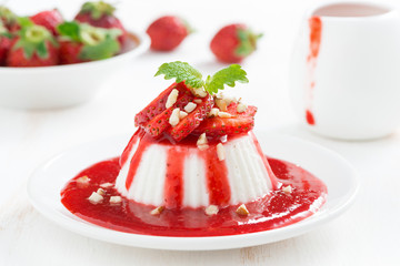 Vanilla panna cotta with strawberry sauce and nuts