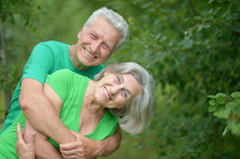 Senior Man Hugging Senior Woman In Forest