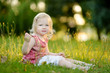 © MNStudio - Cute little toddler girl sitting on the grass
