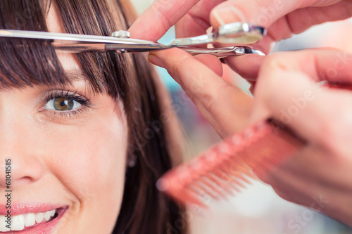 Fotografie, Obraz Hairdresser cutting woman bangs hair in shop
