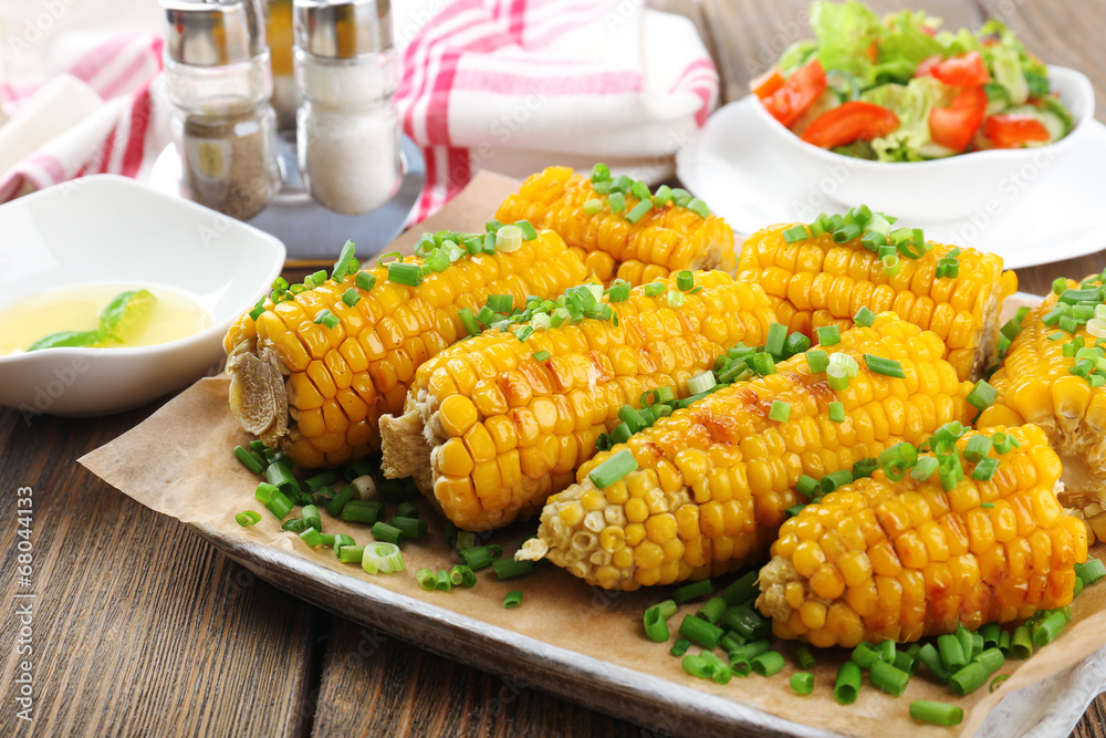 Grilled corn cobs on table, close-up