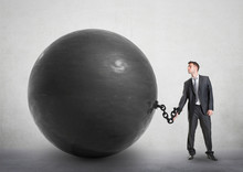 Businessman Chained To A Large Ball