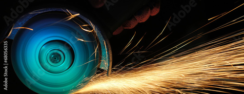 Worker cutting metal with grinder Poster Mural XXL