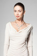 © matusciac - beautiful woman wearing marble necklace on grey background