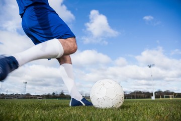 Poster - Football player in blue about to kick ball