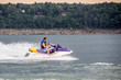 Young Man piloting a personal water craft