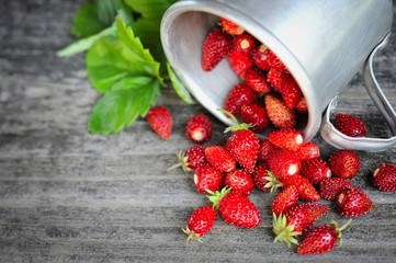 fresh wild strawberries on an old wooden table