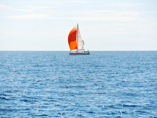 Sticker - yacht with red sail in blue Adriatic sea