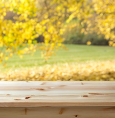 Wall Mural - Empty wooden table against autumn background