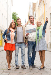 Canvas Print - group of smiling friends with map and photocamera