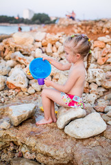 little girl playing on the beach