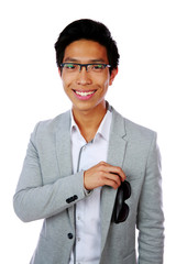 Wall Mural - Portrait of a happy asian man over white background