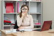 © madhourse - Girl looking through a magnifying glass in the office