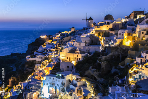 Plakat na zamówienie typical view of houses and buildings in Oia village at night