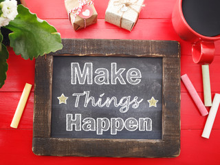 Make Things Happen on chalkboard on red table