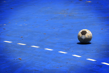 Old ball in a blue cement field