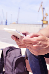 Wall Mural - young man using a tablet or an e-book outdoors