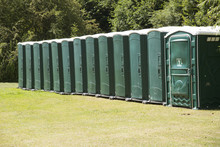 Plastic Portable Toilets Standing In A Field