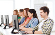 © Syda Productions - male student with classmates in computer class