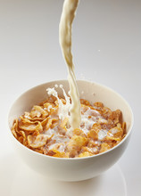 Milk Pouring Into Bowl With Corn Flakes