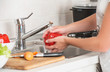 © JenkoAtaman - woman washing vegetables red pepper under the tap