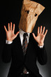 紙袋で顔を隠したスーツのビジネスマン