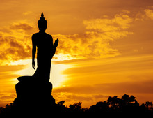 Walking Buddha Statue Silhouette At Sunset