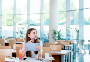 Girl studying in the University canteen with Fresh and cake