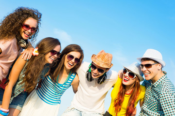 Wall Mural - group of young people wearing sunglasses and hat