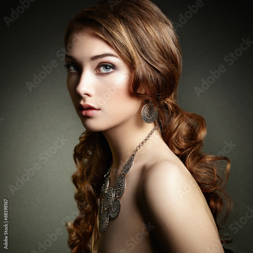 Naklejka na meble Beauty woman with long curly hair. Beautiful girl with elegant h