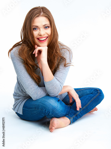 Fotografía Young woman sitting on a floor. Isolated on white background