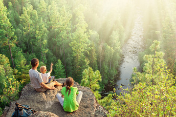 Family of backpackers look at beautiful view