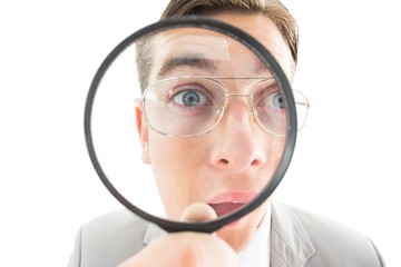 Poster - Geeky businessman looking through magnifying glass