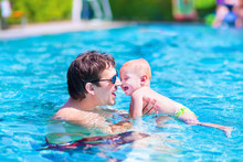Father And Baby In A Swimming Pool