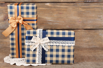 Gift boxes with colorful ribbon on wooden background