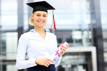 Poster - Happy graduate standing outside modern building