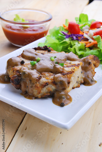 Fototapeta na szkło Grilled steaks, pork with pepper gravy and vegetable salad