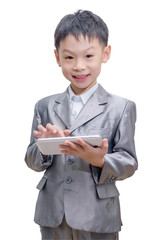 Asian boy in suit using tablet computer on white background