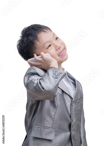Valokuva Asian boy in suit talking on mobile phone over white background