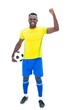 © WavebreakmediaMicro - Football player in yellow celebrating a win