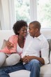 © WavebreakmediaMicro - Happy couple relaxing on the couch
