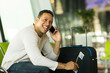 © michaeljung - man talking on cell phone at airport