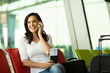 © michaeljung - woman talking on mobile phone at airport