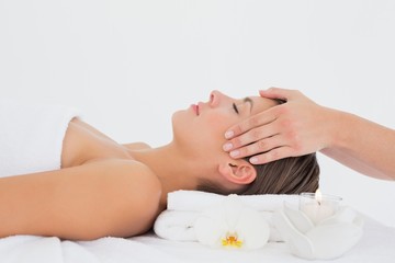 Wall Mural - Attractive young woman receiving head massage at spa center