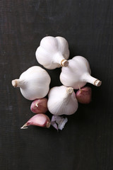 Wall Mural - Garlic on black wooden background