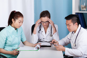 Wall Mural - Doctors working next to table