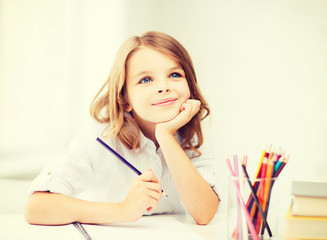 Wall Mural - girl drawing with pencils at school