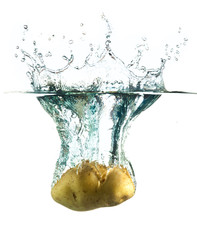 Sticker - potatoes splashing into water against a white background.