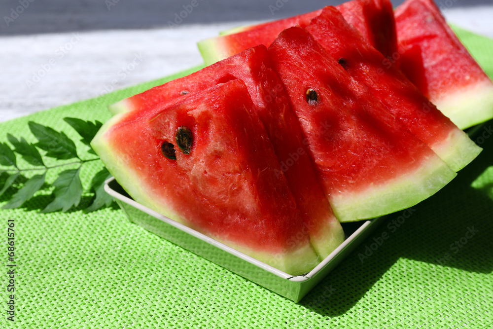 Fresh slices of watermelon on table, outdoors