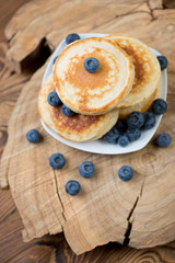 Wall Mural - Homemade fritters with blueberries over rustic wooden surface